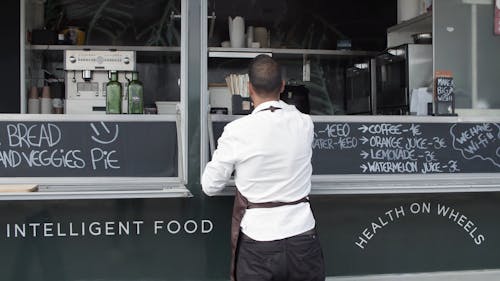 Man Preparing and Putting Cup and Glass bottles on Counter