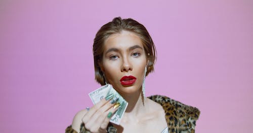 A Woman Wiping Her Lips Using Money