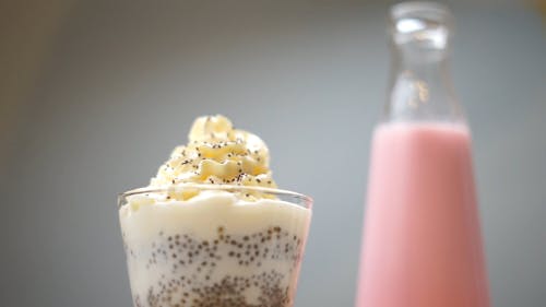 A Person Sprinkling Chocolate Sprinklers on Top of a Smoothie