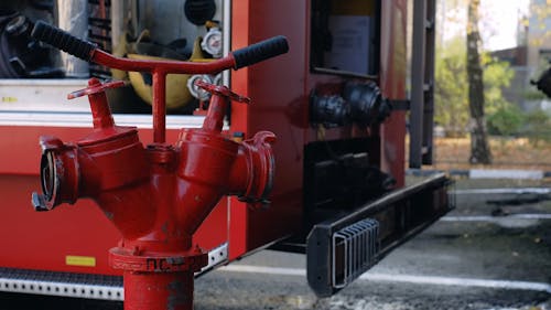 A Firefighter Putting Hose in the Water Tank