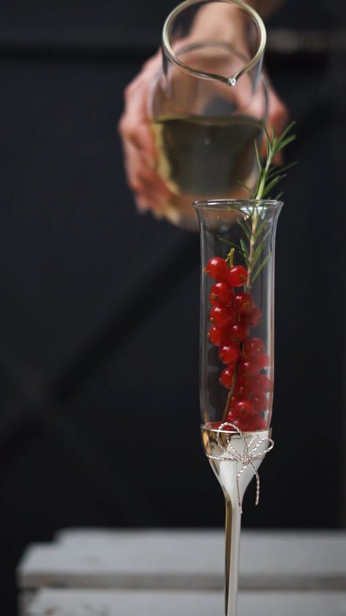 Wine Poured in a Berry-Filled Glass