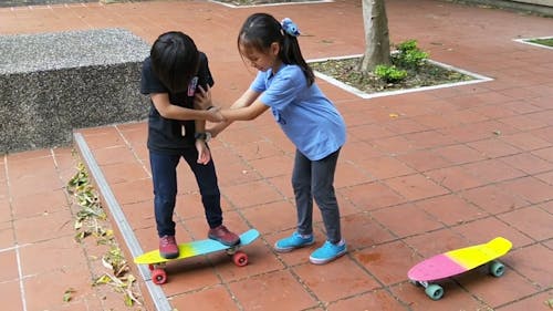 Children Playing with Skateboards Outdoors