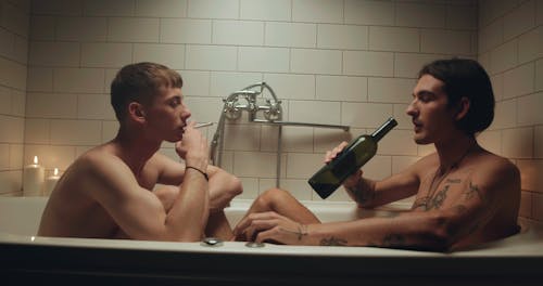 Men in Bathtub Drinking while Smoking