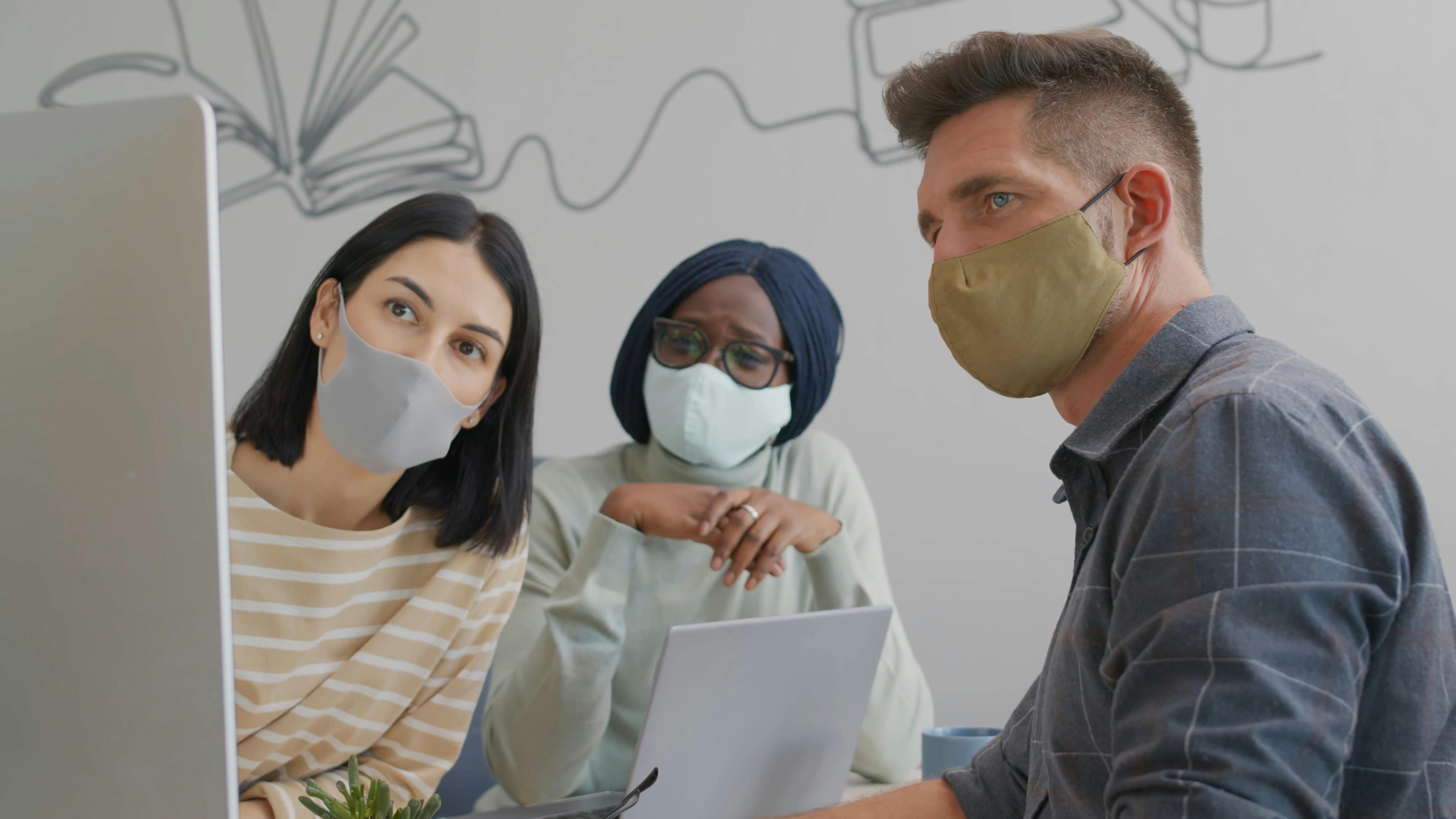 Colleagues In Face Mask Looking At A Computer Monitor · Free Stock Video