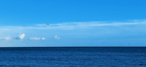 An Airplane Flying Over The Sea