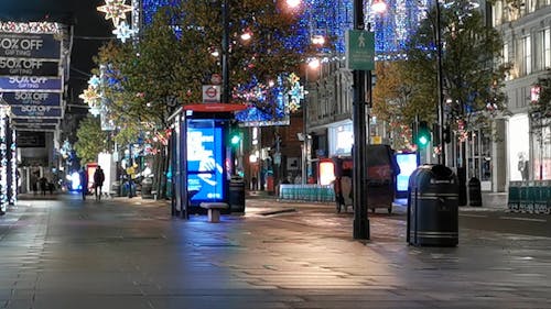 A Bright Street In London Filled With Christmas Lights