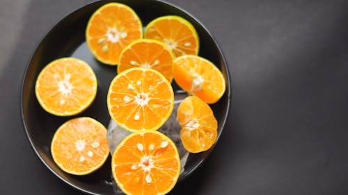 Putting Sliced Oranges on a Plate