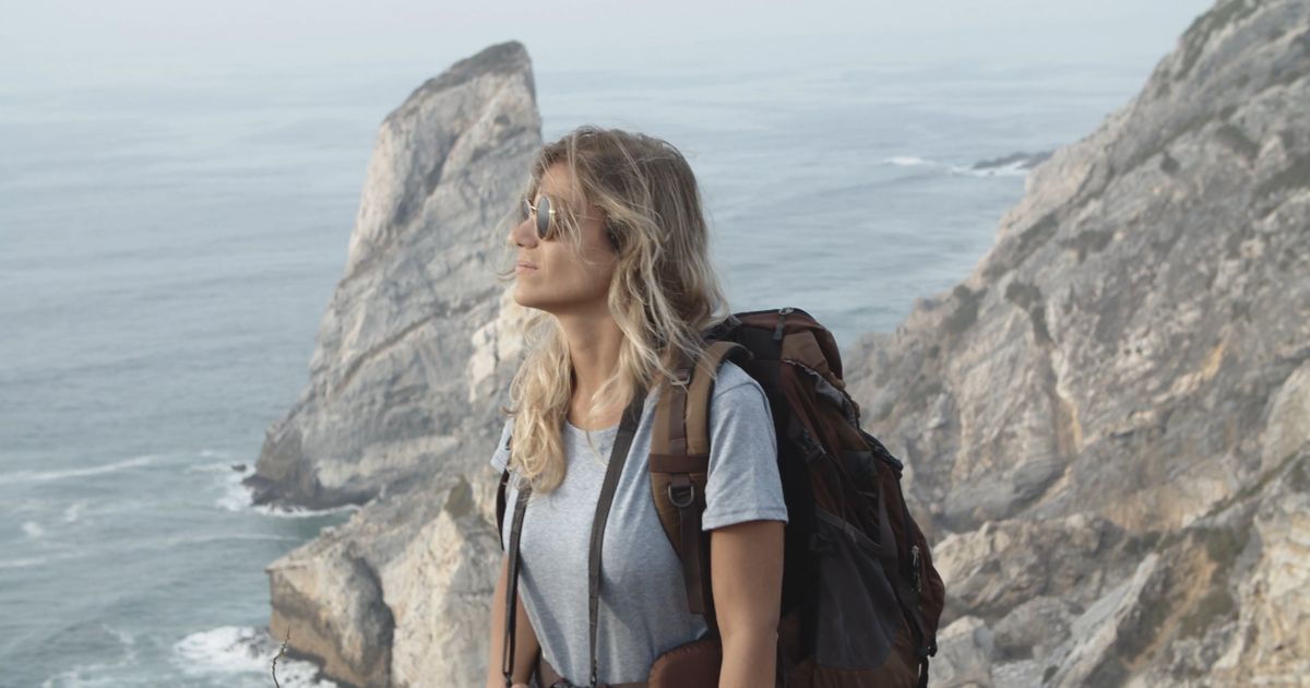 hiker on shore passing by a tent 5945592