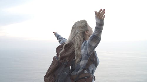 Woman Standing on a Cliff