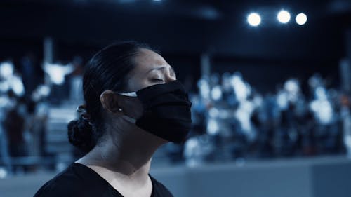 Woman Wearing Black Face Mask While Praying