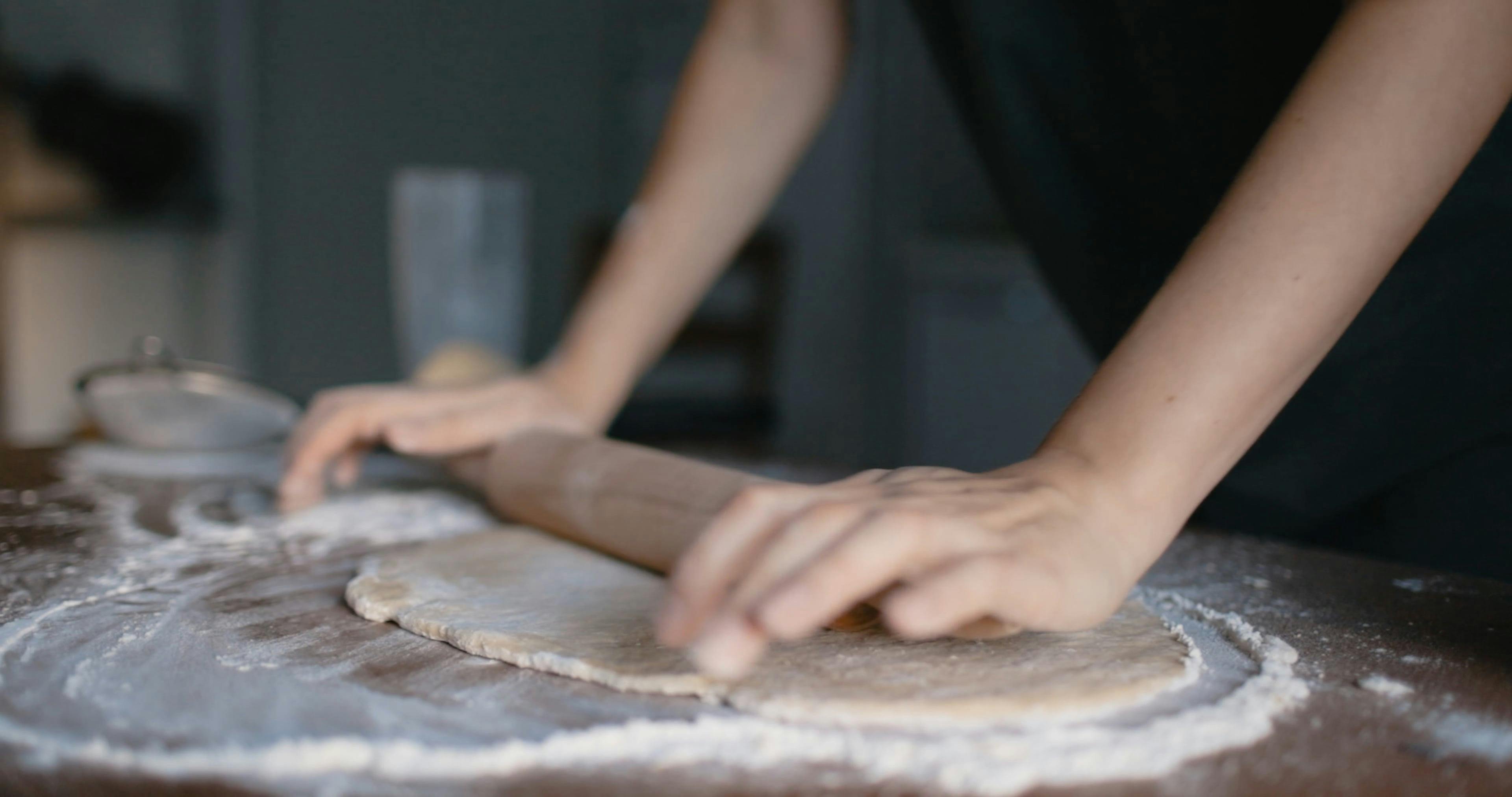 A Person Flattening Dough Using a Rolling Pin · Free Stock Video