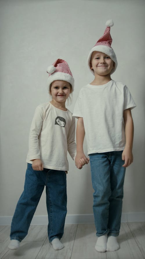 Siblings Posing and Smiling in Front of a Camera