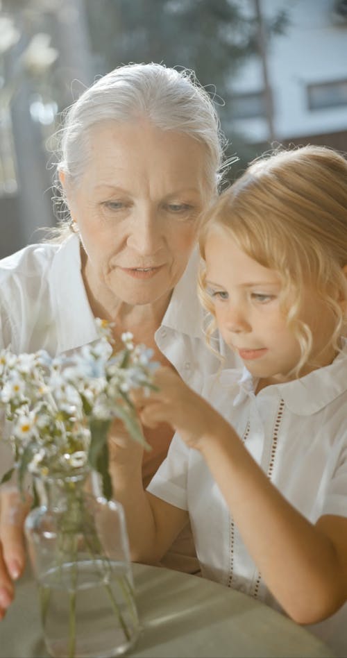 A Grandmother Talking to Her Granddaughter About Flowers