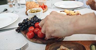people picking foods on a table