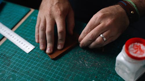 A Person Sanding the Leather Fabric