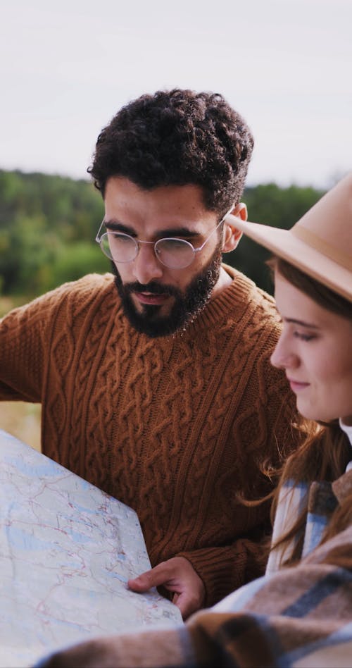 A Man Looking at a Map with a Woman