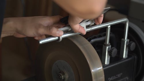 A Person Sharpening a Tool