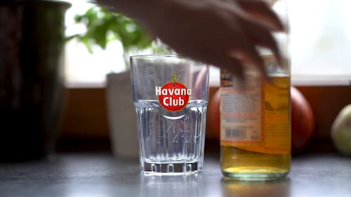 A Person Pouring a Drink in the Glass