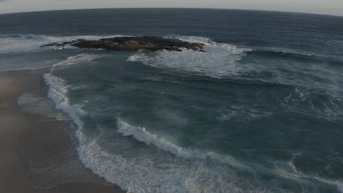 Aerial Shot of Crashing Waves in the Seashore