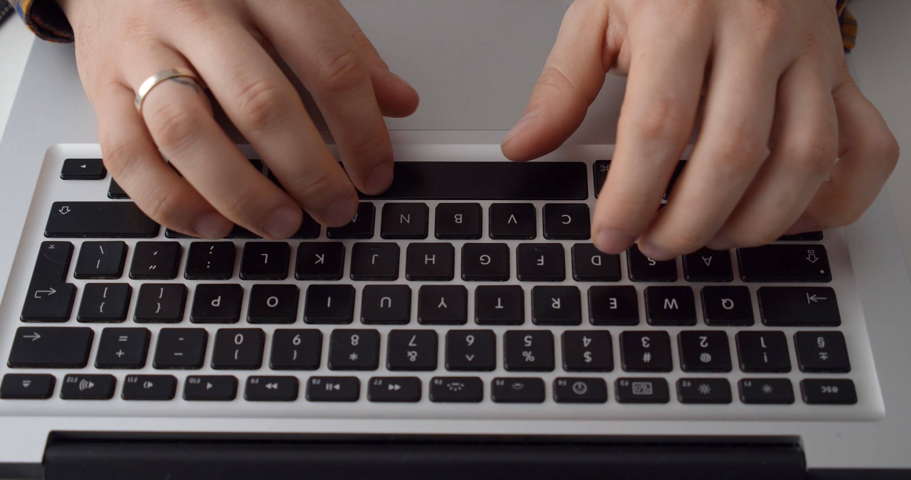 a close up view of a person typing on the keyboard of a laptop 5970673