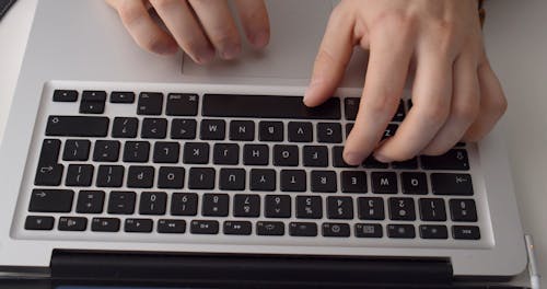 A Person Scrolling on the Laptop Mouse Pad