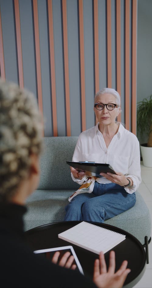 An Elderly Woman Interviewing An Applicant