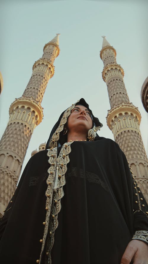 Low Angle Photography Of A Woman Between Two Towers