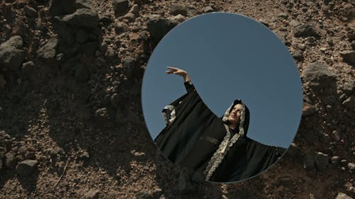 Woman Posing in the Desert Wearing Traditional Abaya