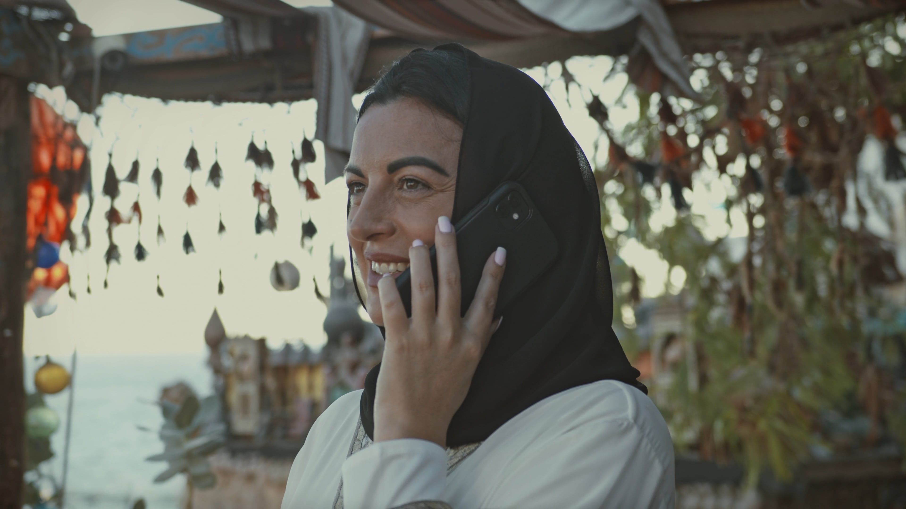 Muslim Woman Talking on Phone Outdoors · Free Stock Video