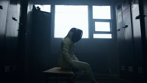 A Fencer Prepping In The Locker Room