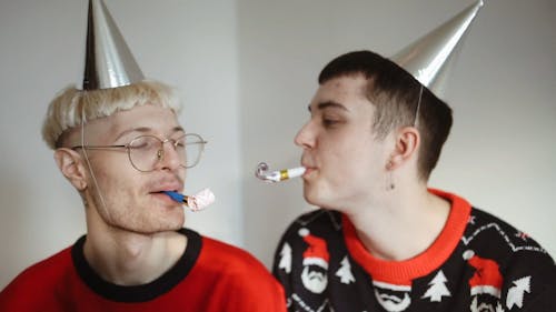 Two Men Playing Party Pipes Together