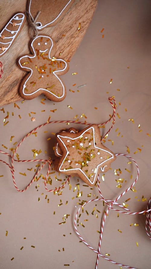 Top View of a Person's Hands Getting a Gingerbread Cookie