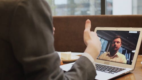 A Man Having a Video Call Through the Laptop