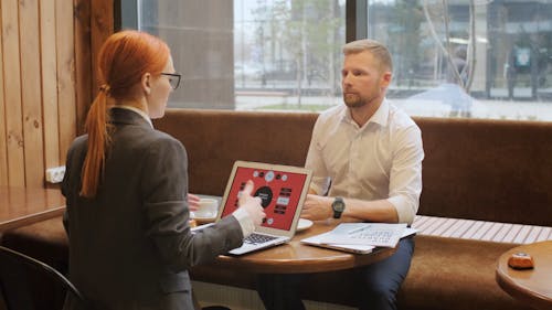 A Man and Woman Talking to Each Other in a Café