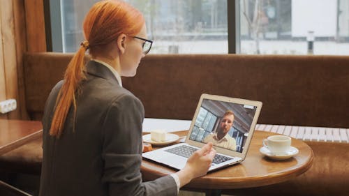 A Woman In A Video Call While Having Snack