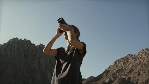 A Woman Taking Photos Using a Digital Camera