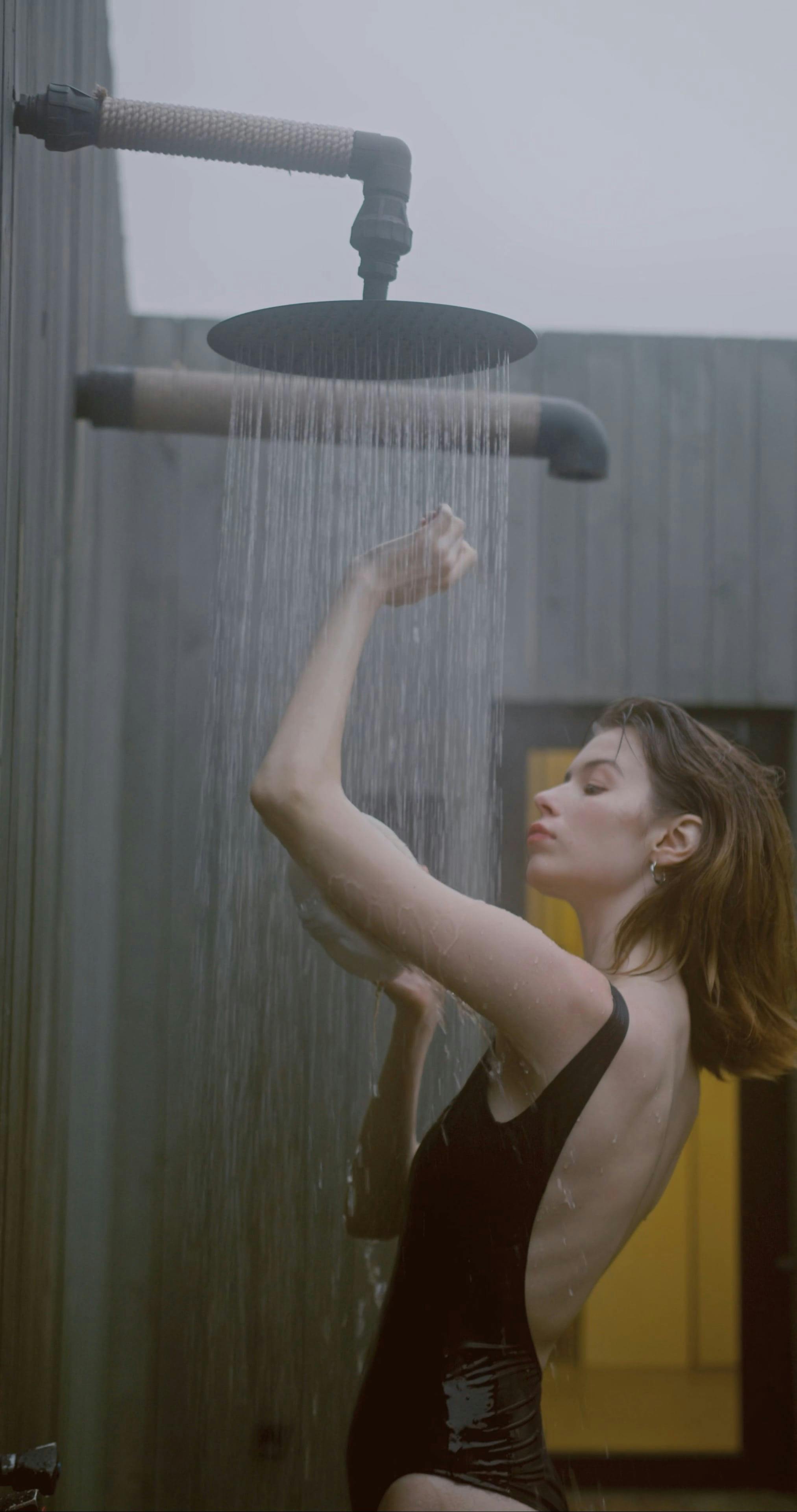 A Woman in Black Bathing Suit Taking a Shower · Free Stock Video