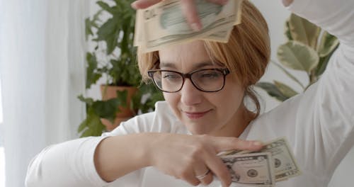 Woman Celebrating with Money in her Hands