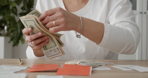 A Woman Feeling Ecstatic In Gathering Her Money