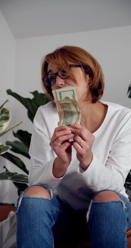 A Woman Holding Cash Money