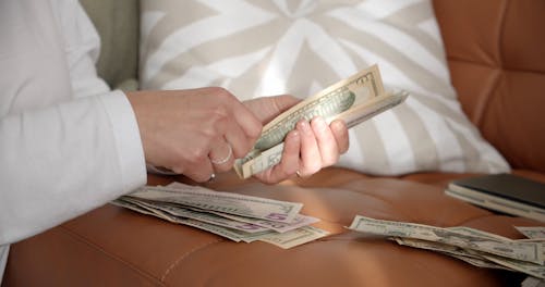 A Person Counting Her Money