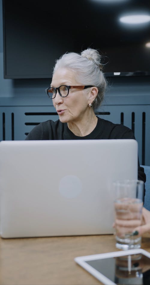 An Elderly Woman Holding A Business Meeting