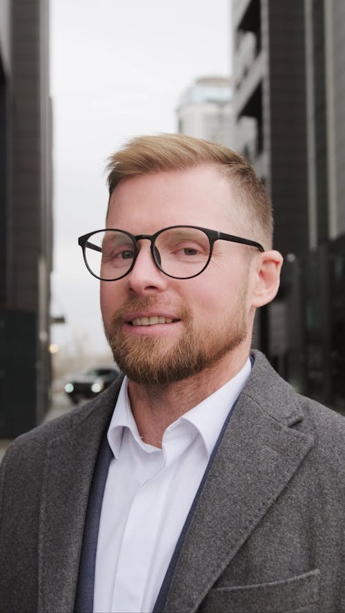 Man in Gray Coat Happily Looking at the Camera