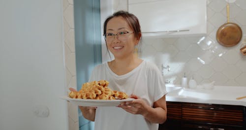 Mom Serving Freshly Cooked Waffles to Her Children