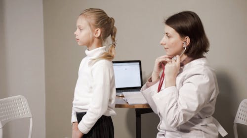 A Doctor Examining A Young Girl
