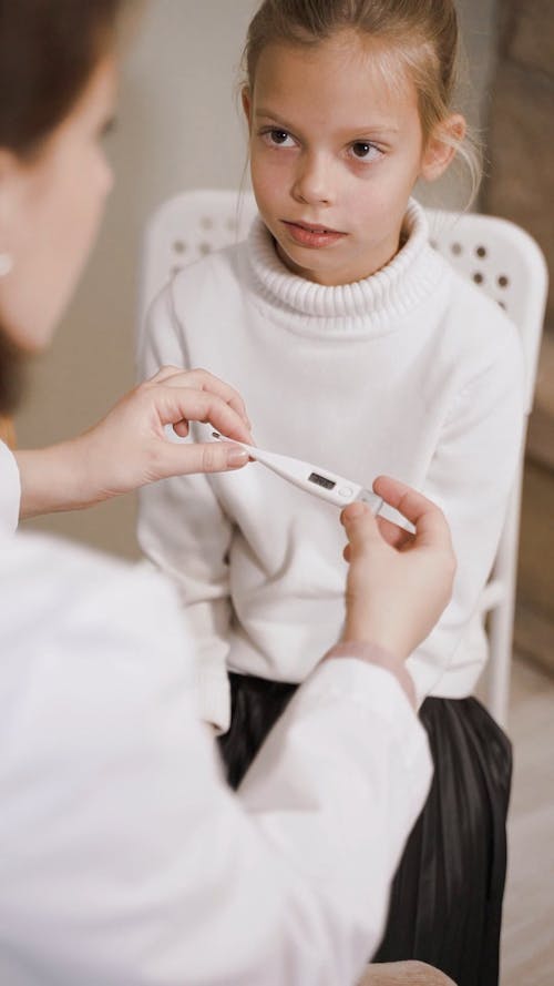 A Doctor Checking The Patient Body Temperature