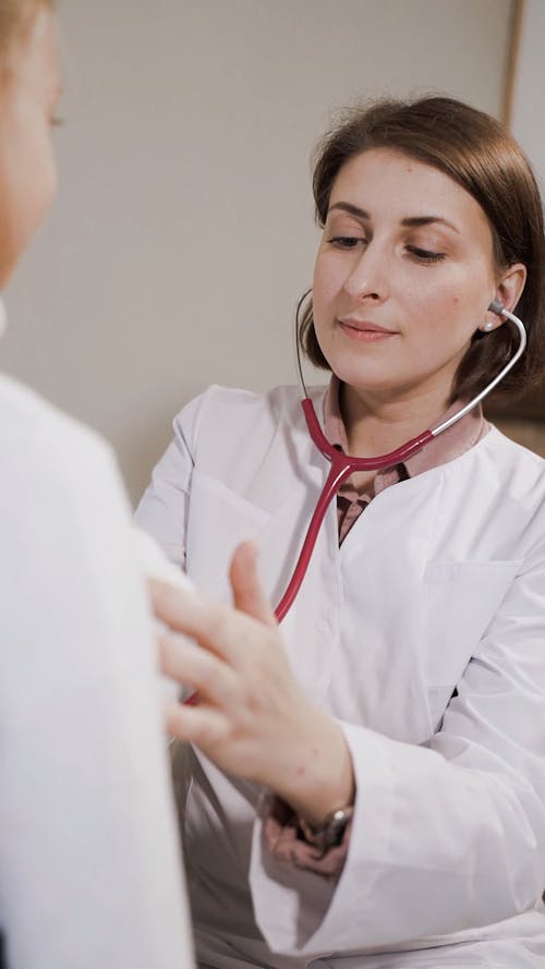 A Lady Doctor Examining Her Young Patient