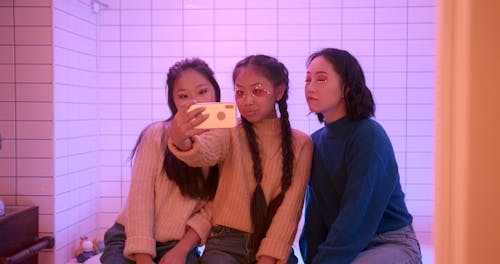 Three Sisters Taking Selfie Using a Smartphone