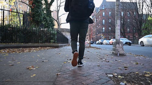 Man Walking on the Sidewalk