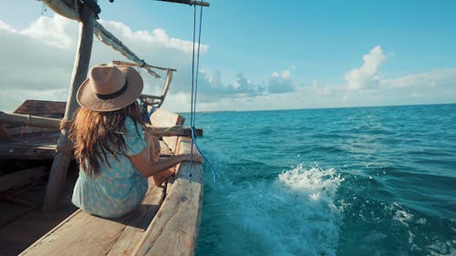 Woman Traveling on Wooden Boat